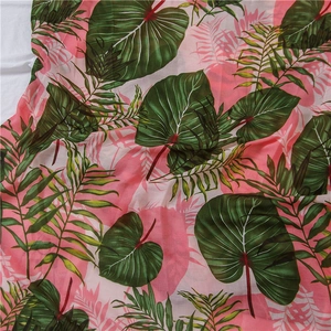 Detail of tropical green leaf print on lightweight cotton linen scarf with fringe