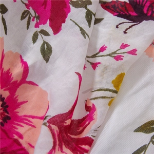 Macro detail of breathable cotton-linen fabric with vibrant pink floral and butterfly print