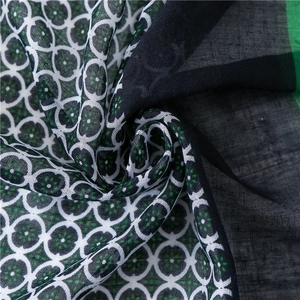 Macro view of forest green and black scarf with elegant circular geometric patterns