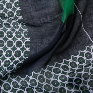 Macro shot of elegant polka dot scarf with white chain and green star floral patterns