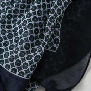 Close-up of lightweight navy blue scarf fabric with vintage geometric floral print