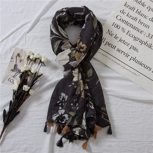 Close-up of floral print cotton scarf with fringe trim and elegant retro flower pattern