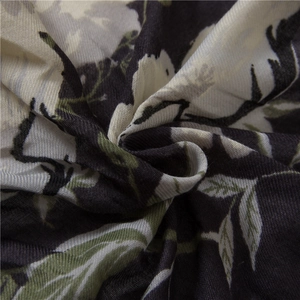 Detail of floral printed cotton linen scarf with large petals and woven texture
