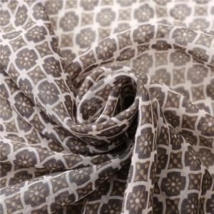 Detailed close-up of retro geometric floral pattern on a soft draped scarf fabric