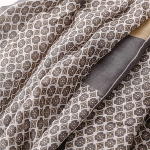 Detail of elegant scarf showing geometric floral weaving and soft fabric texture