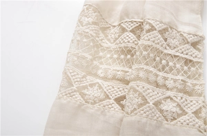 Detailed view of off-white scarf with delicate lace embroidery and mesh patchwork textures