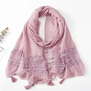 Detail of pink summer scarf featuring floral lace stitching and elegant fringe tassels