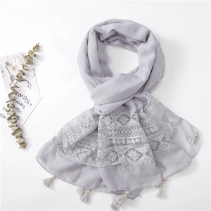 Light purple linen scarf with white floral embroidery and tassels on white background