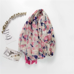 Close-up of lightweight scarf with pink leaves, blue toucans, and bright pink tassels