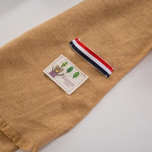 Soft faux cashmere kids scarf in ginger yellow with bear patch and fringe trim