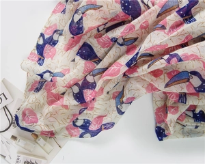 Detail of tropical toucan print on lightweight pink and blue linen texture scarf