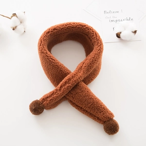 Detailed view of brown plush faux shearling scarf with pompom and crisscross design