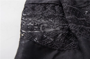 Close-up of black floral lace embroidery detail on elegant summer cotton scarf shawl