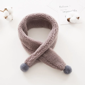 Close-up of soft grey plush fleece toddler scarf with decorative fuzzy balls for winter