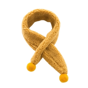 Cross-over plush baby scarf in mustard yellow with decorative pom-poms for winter warmth
