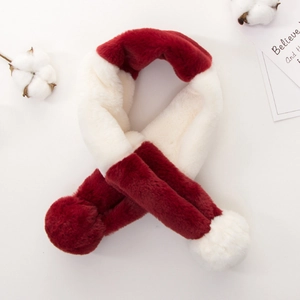 Close-up of red and white plush scarf with soft pom-poms and warm faux fur texture
