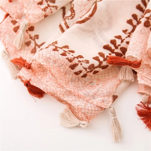 Detail of bohemian blue and white porcelain pattern scarf with dual-tone fringe trim