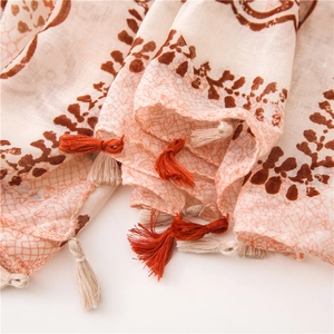 Detail of bohemian geometric pattern shawl with tassels and soft fabric texture