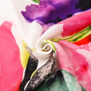 Close-up of lightweight floral scarf showing vibrant multi-color patterns and soft texture