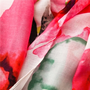 Macro view of floral print scarf showing delicate stitching and fabric texture