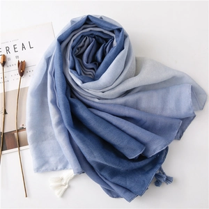 Detail of blue gradient cotton scarf showing soft fabric texture and fringe tassels