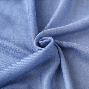 Macro view of light blue cotton scarf showing fine twill weave and soft texture detail