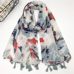 White linen scarf with abstract colorful prints and tassels for a stylish summer look