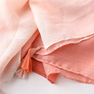 Macro detail of pink gradient cotton scarf showing soft twill texture and handmade tassels