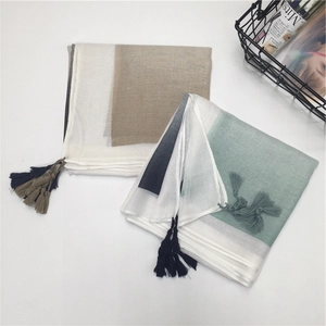 Detail of thin cotton linen scarves with tassels in geometric color block patterns