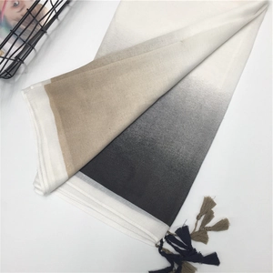 Detail of soft cotton scarf featuring three-color gradient design and fringe tassels