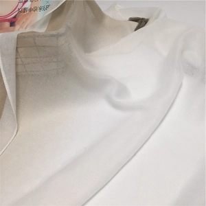 Close-up of lightweight white cotton fabric with delicate weave and sheer texture