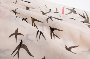Detail of soft mercerized cotton scarf featuring delicate swallow bird print patterns