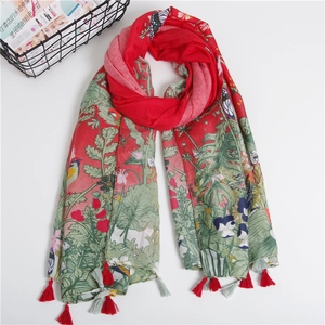 Detail of floral and bird print twill cotton scarf with decorative long tassels