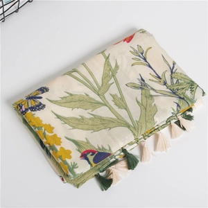 Close-up of floral twill cotton scarf with bird print and soft decorative fringe