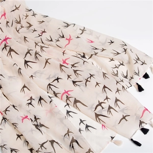 Lightweight cotton scarf with swallow print and tassels in elegant cream color