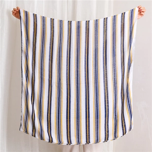 Detail of lightweight blue and yellow striped cotton linen scarf with sheer texture