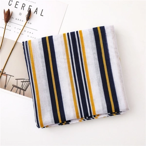 Detailed view of lightweight cotton-linen striped scarf with yellow and blue patterns