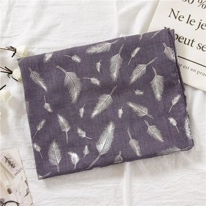 Detail of purple cotton linen scarf with silver feather print and soft elegant texture