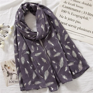 Detail of elegant dark purple cotton linen scarf with shiny silver feather foil prints