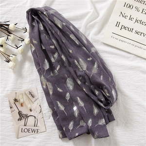 Close-up of elegant purple linen scarf with gold and silver feather foil printing