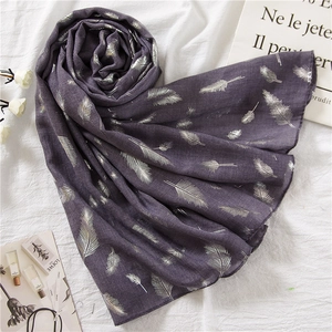 Elegant purple linen scarf with silver feather prints on a white textured background