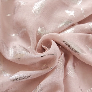 Macro shot of soft pink cotton-linen scarf with elegant silver feather foil print patterns