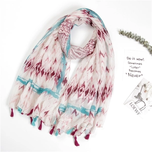 Detail shot of light cotton scarf featuring colorful waves and decorative tassels