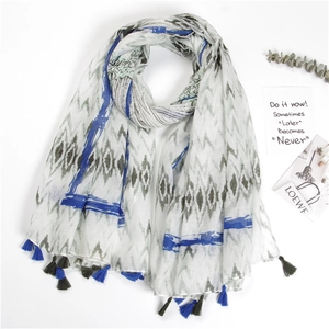 Detailed view of linen scarf with geometric diamond prints and soft blue tassels