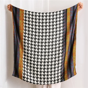 Detail view of the houndstooth pattern and floral lace stitching on this cotton linen scarf