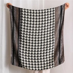 Detail of houndstooth scarf with brown floral lace splicing and soft draped edges