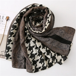 Detail of long houndstooth scarf showing elegant lace patchwork and premium cotton texture