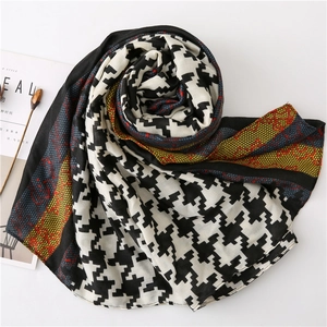 Detail of houndstooth scarf featuring colorful vintage prints and lace mesh textures