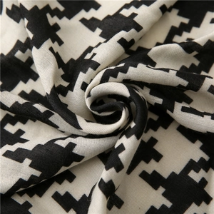 Close-up of black and white houndstooth scarf showing soft cotton linen texture and weave