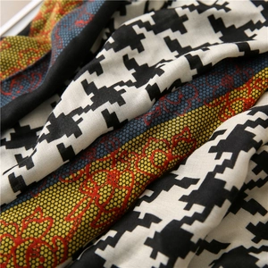 Detail of houndstooth scarf with elegant lace patchwork and floral texture